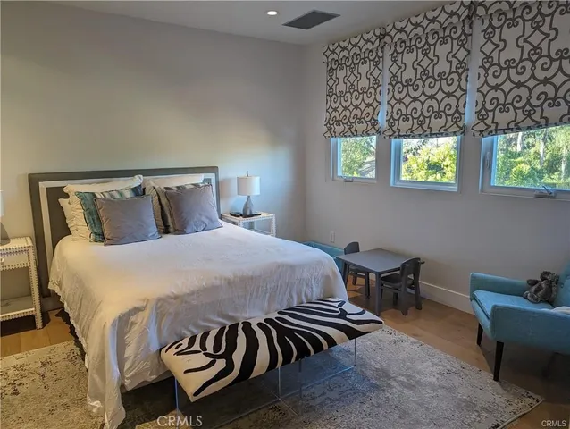 a bed sitting in a bedroom next to a window