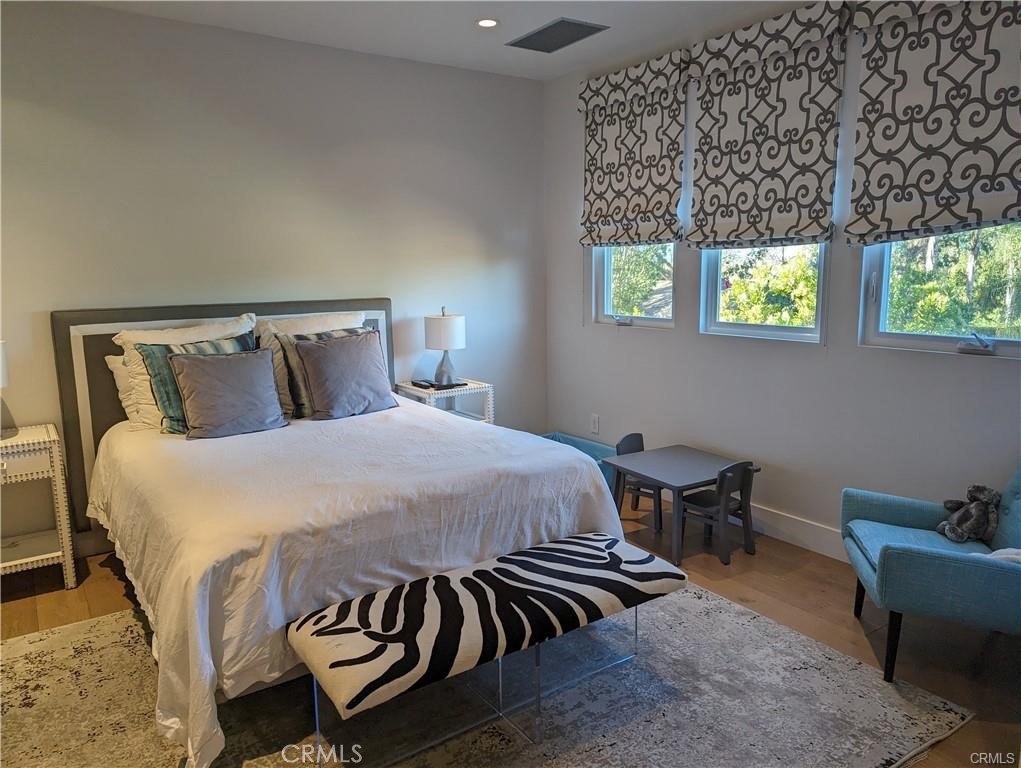 17950 Rancho Street Encino, CA 91316 - Photo 23 of 35 a bed sitting in a bedroom next to a window