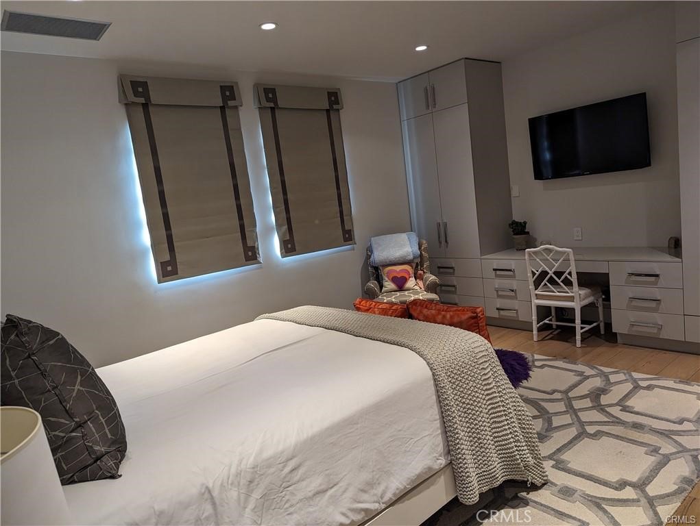 17950 Rancho Street Encino, CA 91316 - Photo 27 of 35 a bedroom with a bed a television and a large window