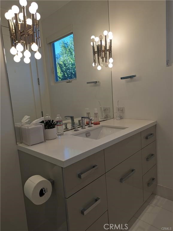 17950 Rancho Street Encino, CA 91316 - Photo 28 of 35 a bathroom with a sink vanity and a mirror