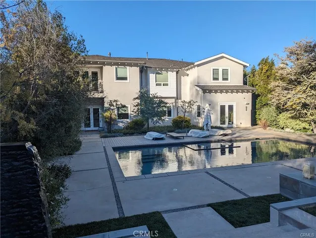 a front view of a house with swimming pool and porch