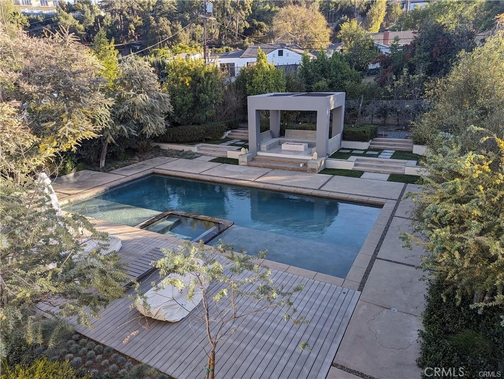 17950 Rancho Street Encino, CA 91316 - Photo 30 of 35 a view of a swimming pool with a patio