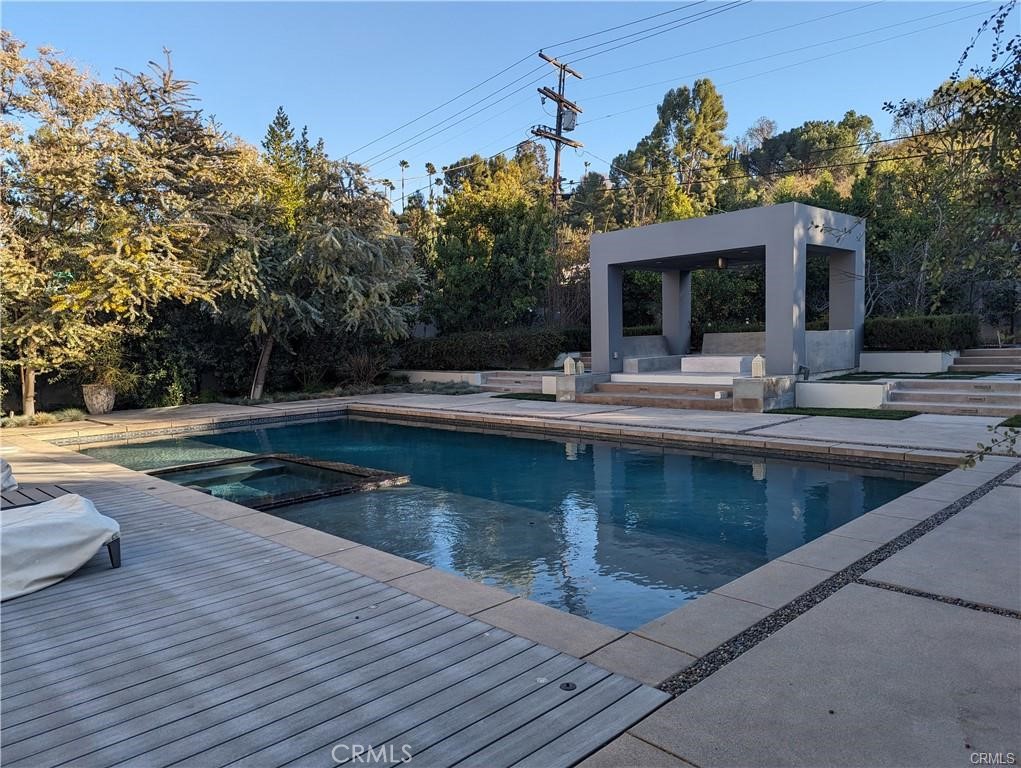 17950 Rancho Street Encino, CA 91316 - Photo 31 of 35 a view of a house with swimming pool and sitting area