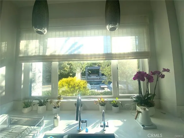 a living room with patio furniture and a floor to ceiling window