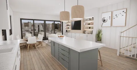 a view of kitchen island with stainless steel appliances refrigerator stove dining table and chairs