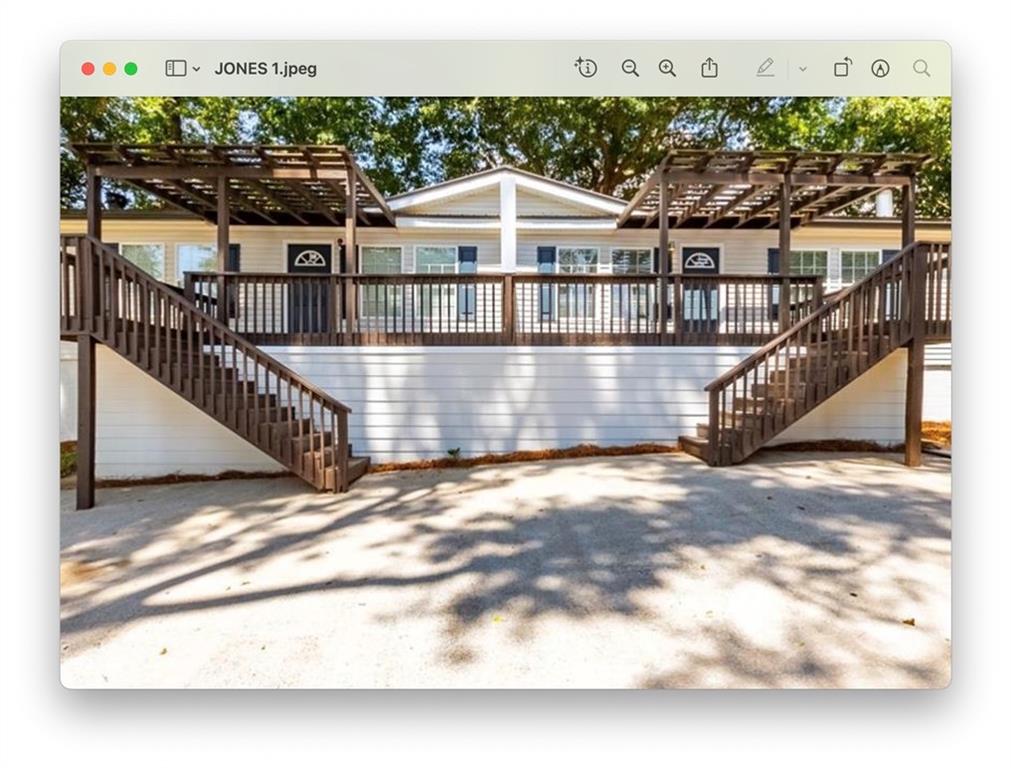 6140 Jones Road Flowery Branch, GA 30542 - Photo 1 of 4 a view of a house with a wooden deck