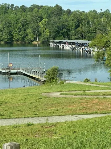 a view of a lake with a yard and trees