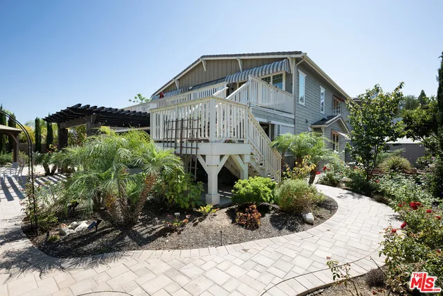 a kitchen with stainless steel appliances granite countertop white cabinets and a sink