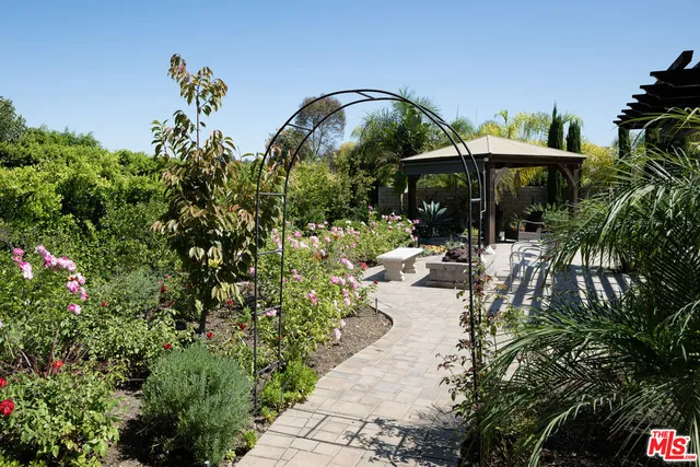 a bathroom with a sink a toilet a mirror and shower