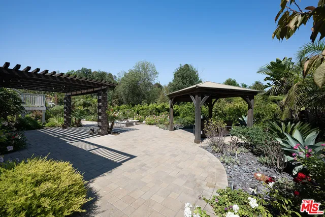 a view of a kitchen with wooden floor and a window