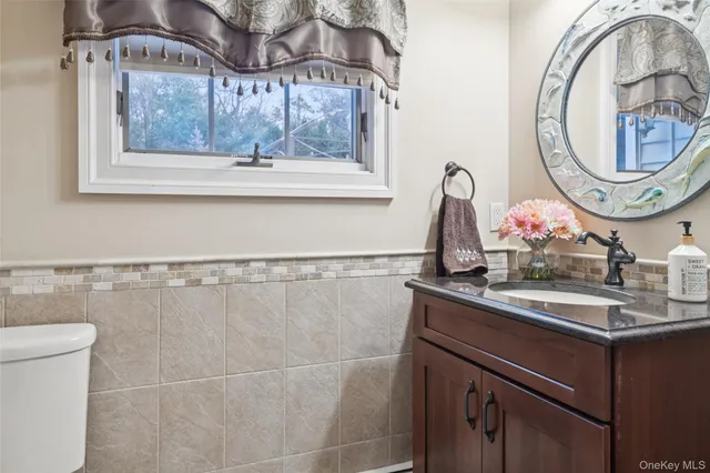 a bathroom with a sink a mirror and a window