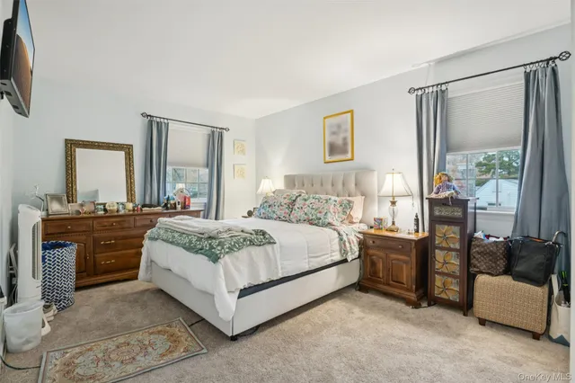 a spacious bedroom with a large bed and a dresser