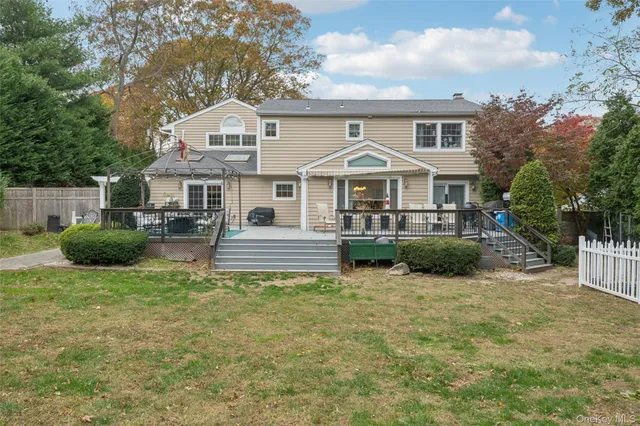a front view of a house with a patio and a yard