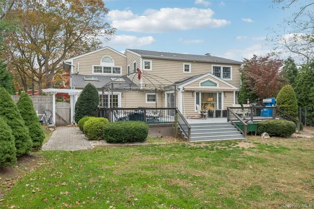 a front view of a house with a yard and potted plants