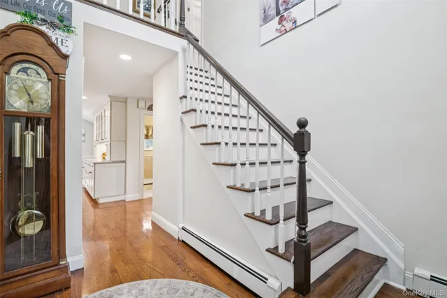 a view of entryway and hall with wooden floor
