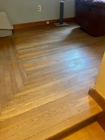 a view of a room with wooden floor