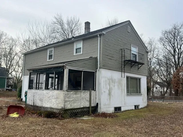 a view of a white house with large windows