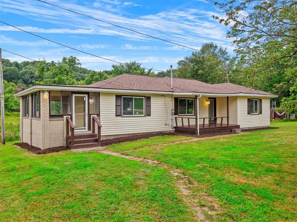 a front view of a house with a yard table and chairs