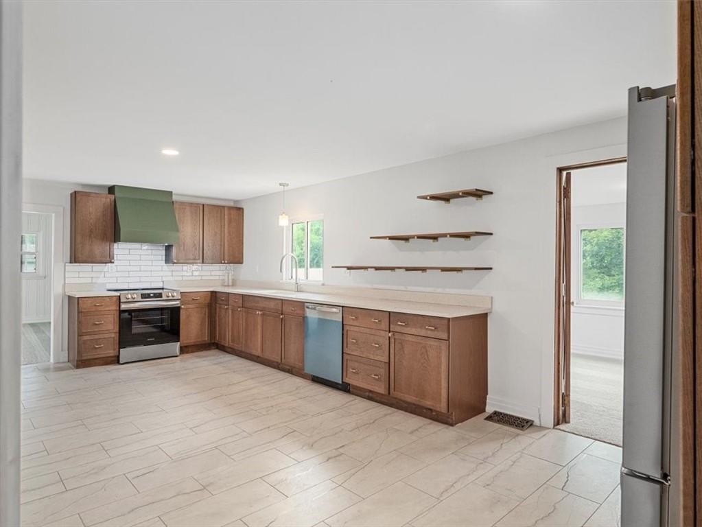 1403 Blackhawk Road Darlington, PA 16115 - Photo 11 of 29 a kitchen with stainless steel appliances a sink and a refrigerator