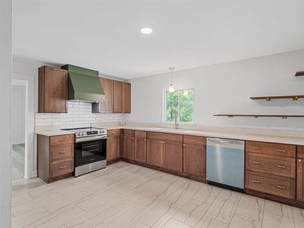 1403 Blackhawk Road Darlington, PA 16115 - Photo 12 of 29 a large kitchen with stainless steel appliances granite countertop a stove a sink dishwasher and a refrigerator