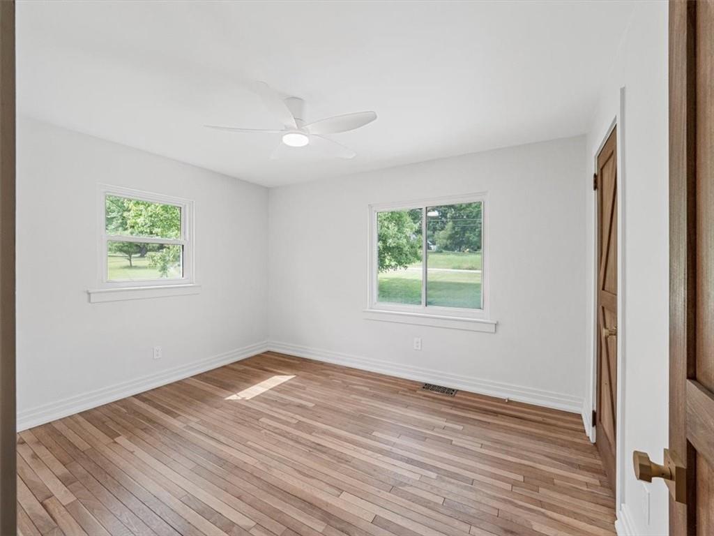 1403 Blackhawk Road Darlington, PA 16115 - Photo 23 of 29 a view of empty room with wooden floor and fan