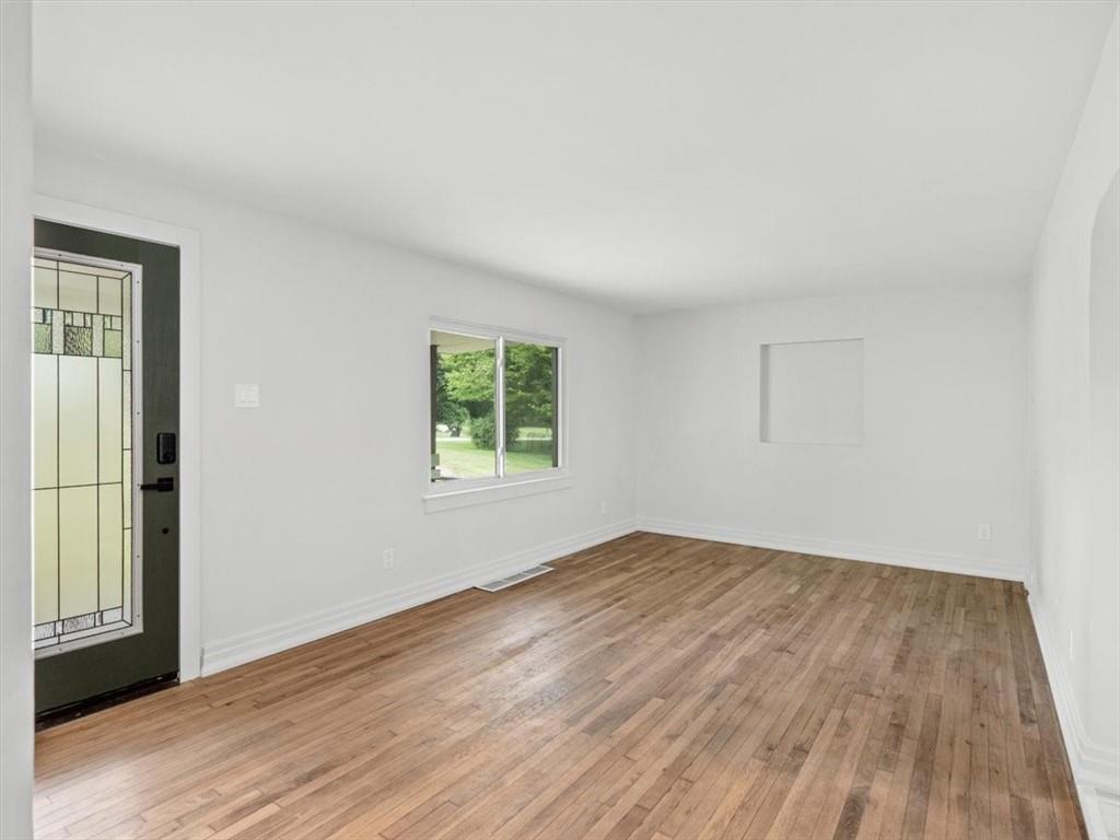 1403 Blackhawk Road Darlington, PA 16115 - Photo 6 of 29 an empty room with wooden floor and windows