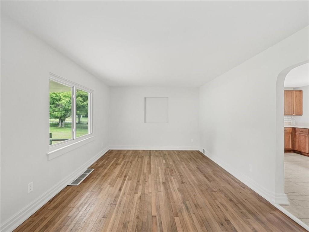 1403 Blackhawk Road Darlington, PA 16115 - Photo 7 of 29 an empty room with wooden floor and windows