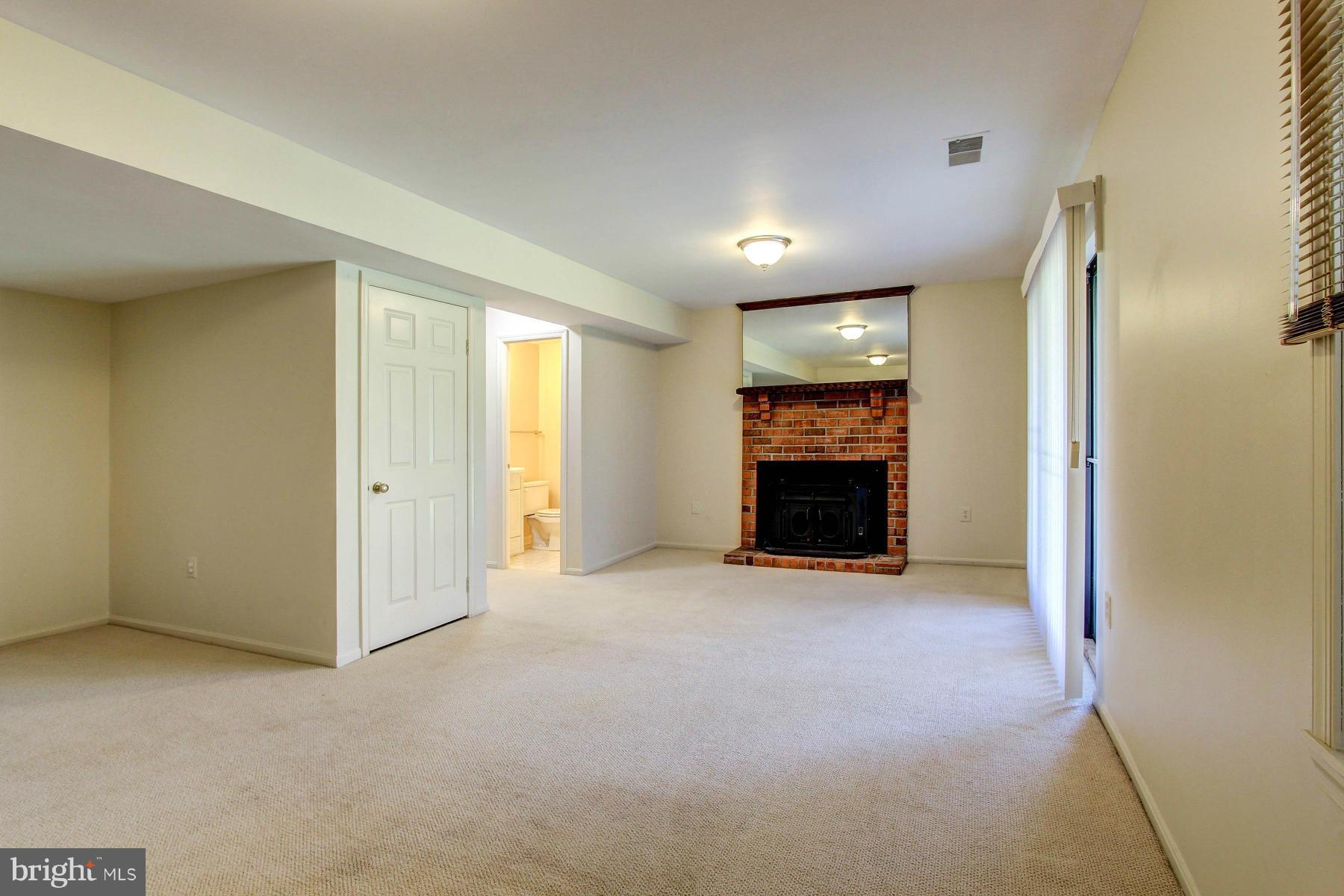 11526 Pine Cone Court Reston, VA 20191 - Photo 25 of 30 Rec Room Features Second Fireplace with Wood Stove