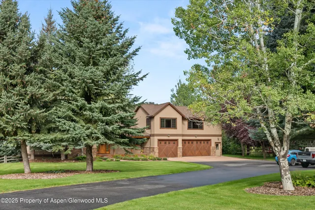 a bathroom with a granite countertop toilet a sink and a mirror