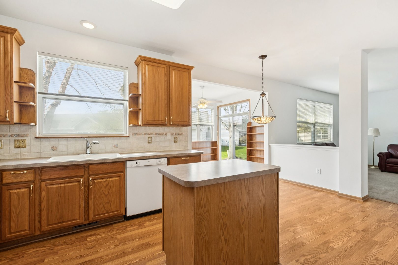 647 South Cadillac Circle Romeoville, IL 60446 - Photo 14 of 38 a kitchen with stainless steel appliances granite countertop a sink a stove and a wooden floors