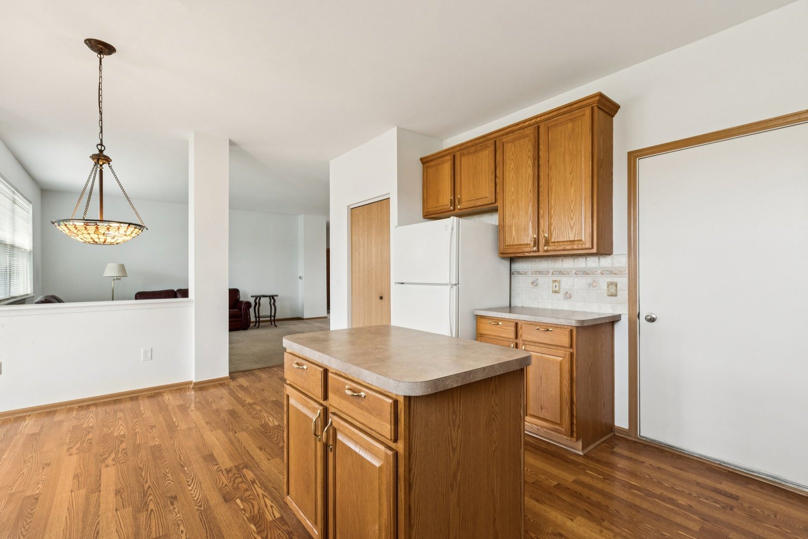 647 South Cadillac Circle Romeoville, IL 60446 - Photo 15 of 38 a kitchen with granite countertop a sink cabinets and wooden floor