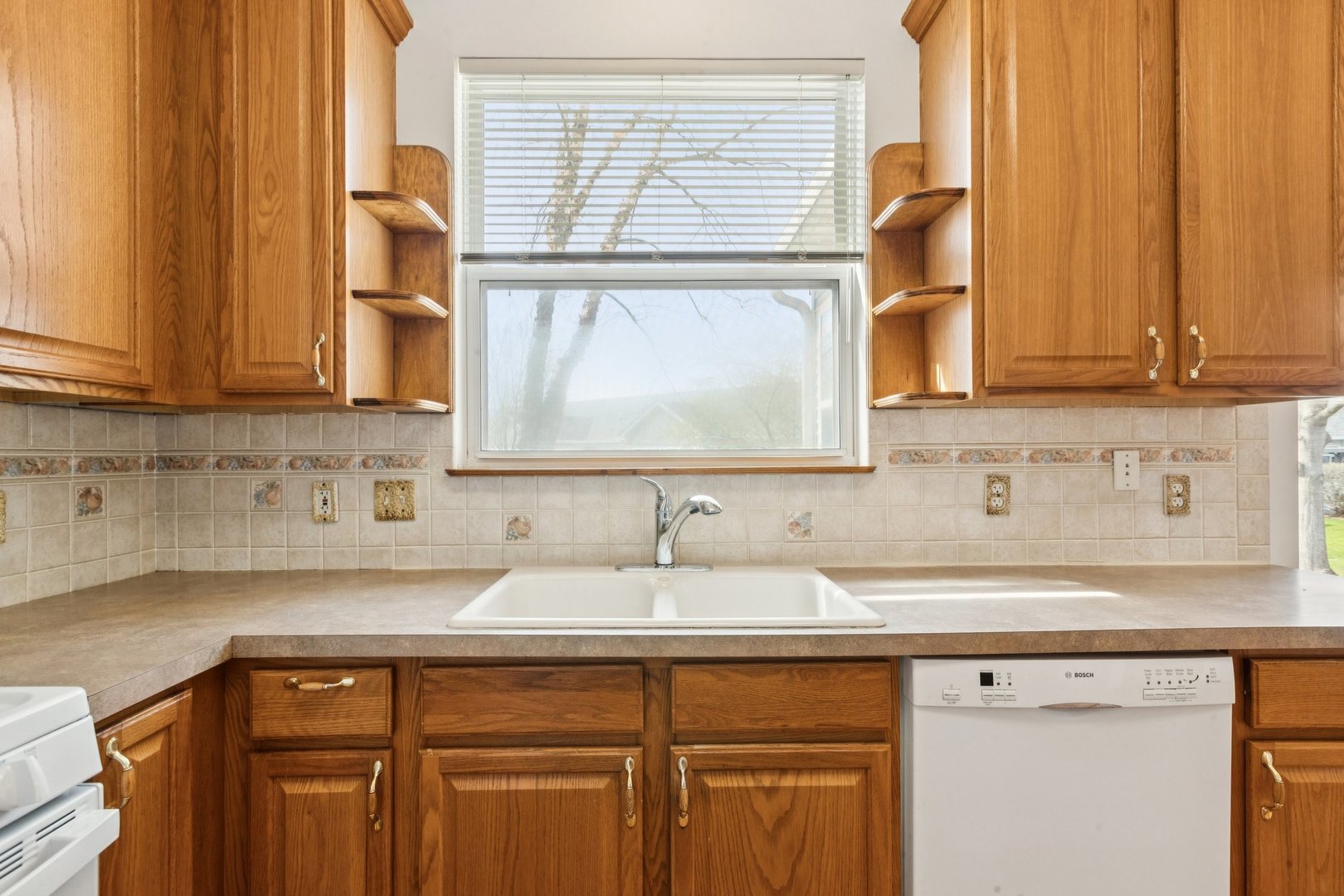 647 South Cadillac Circle Romeoville, IL 60446 - Photo 16 of 38 a view of a sink a window and cabinets
