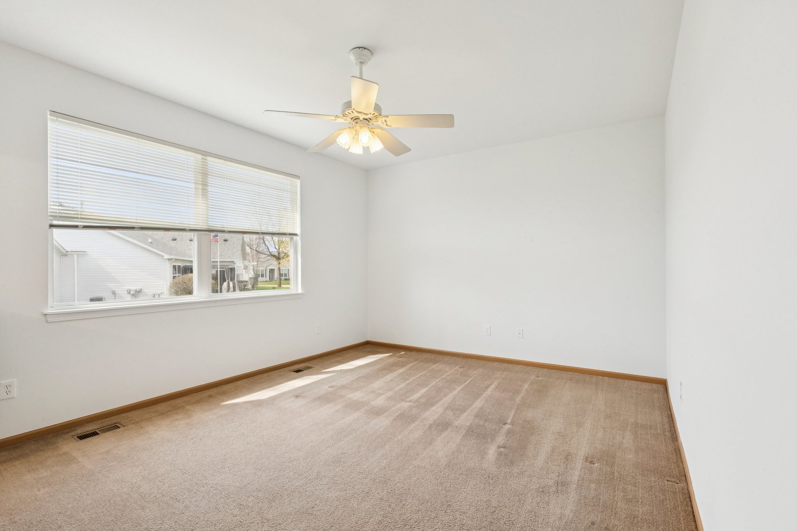 647 South Cadillac Circle Romeoville, IL 60446 - Photo 21 of 38 an empty room with windows and fan