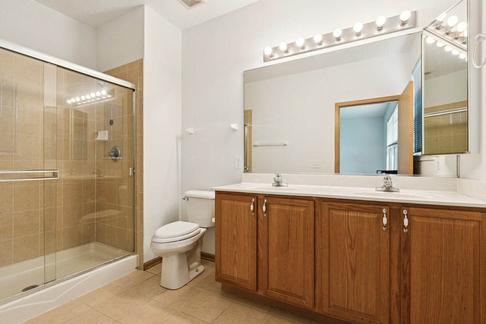 647 South Cadillac Circle Romeoville, IL 60446 - Photo 24 of 38 a bathroom with a double vanity sink toilet and shower