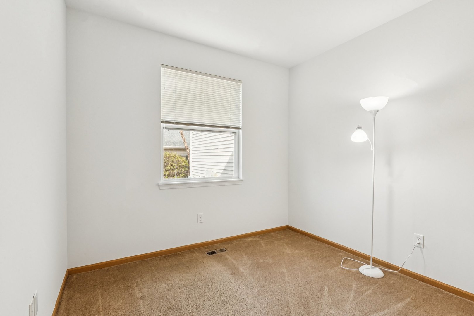 647 South Cadillac Circle Romeoville, IL 60446 - Photo 25 of 38 an empty room with a window