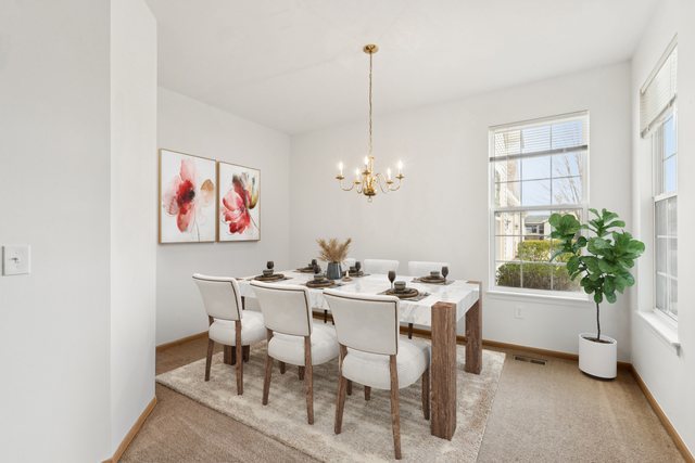 647 South Cadillac Circle Romeoville, IL 60446 - Photo 8 of 38 a view of a dining room with furniture and a potted plant