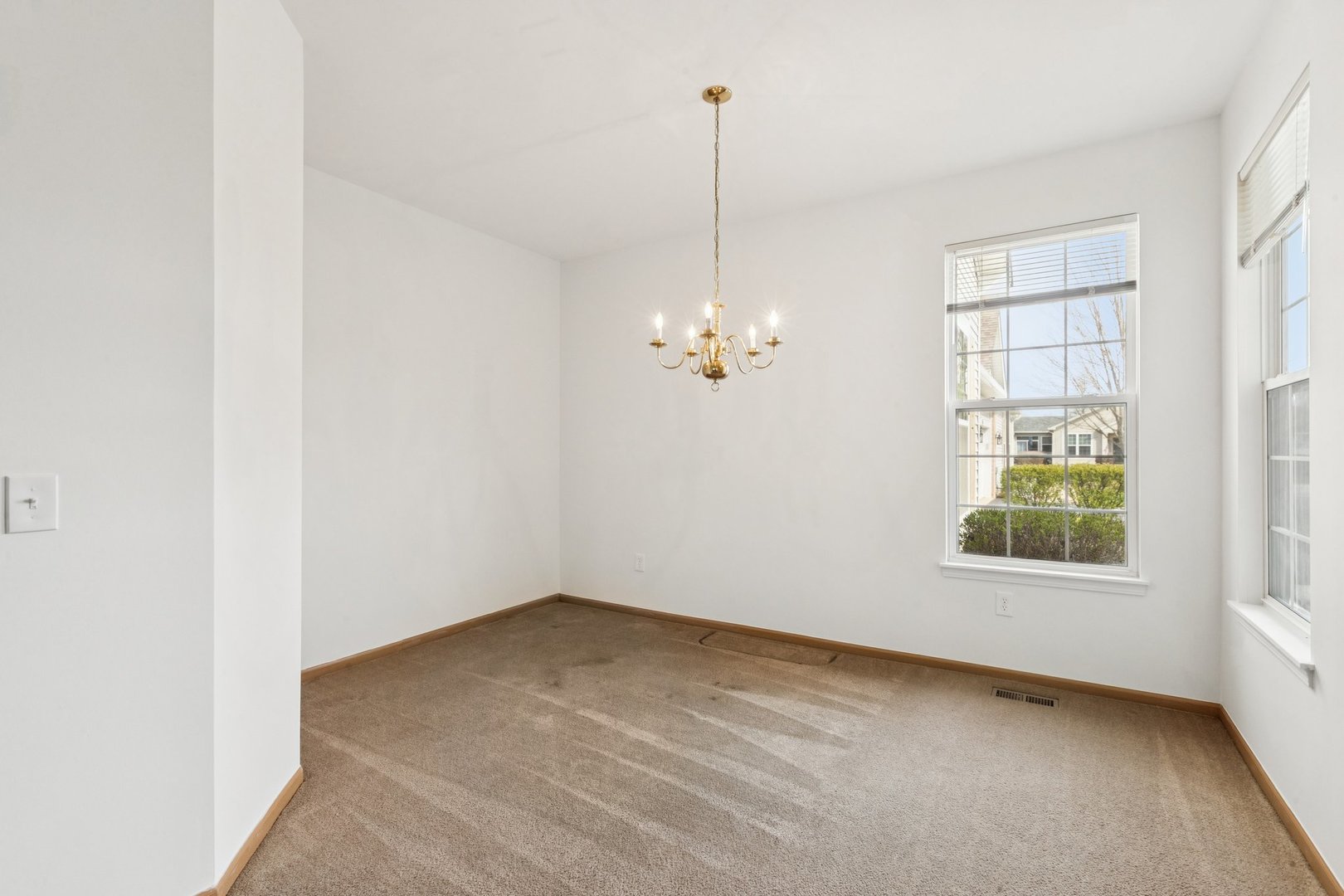 647 South Cadillac Circle Romeoville, IL 60446 - Photo 9 of 38 a view of an empty room with a window