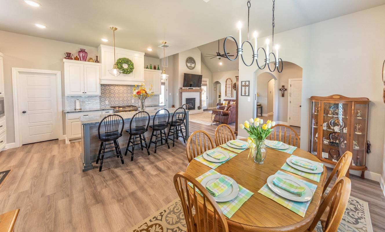 7002 103rd Street Lubbock, TX 79424 - Photo 12 of 28 a view of a dining room with furniture window and wooden floor