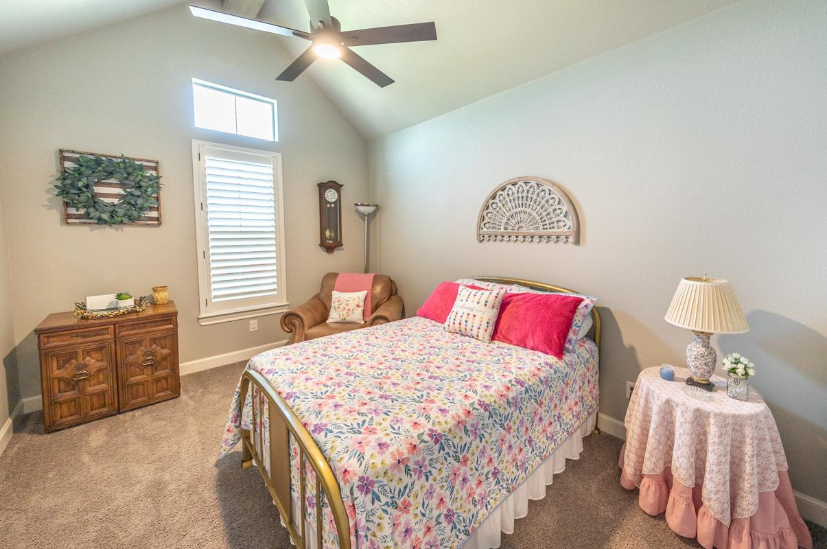 7002 103rd Street Lubbock, TX 79424 - Photo 13 of 28 a bedroom with a bed and a dresser