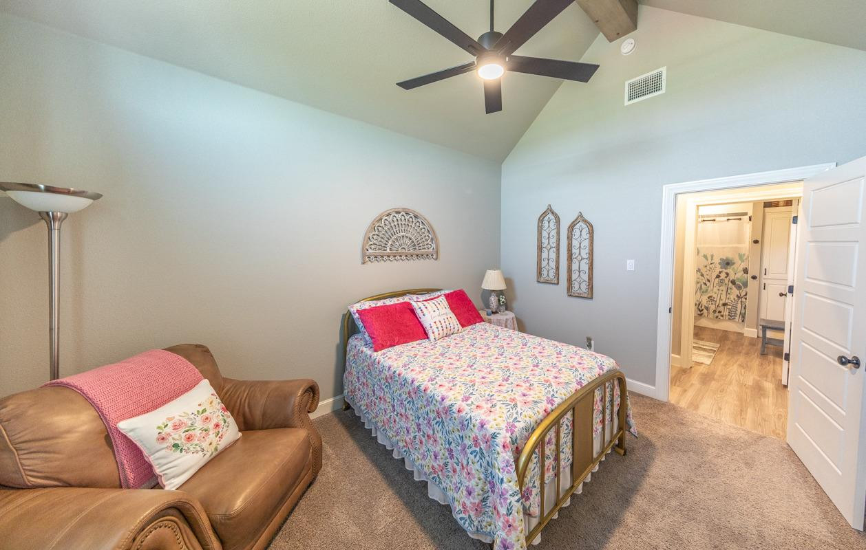 7002 103rd Street Lubbock, TX 79424 - Photo 14 of 28 a bedroom with a bed and dresser