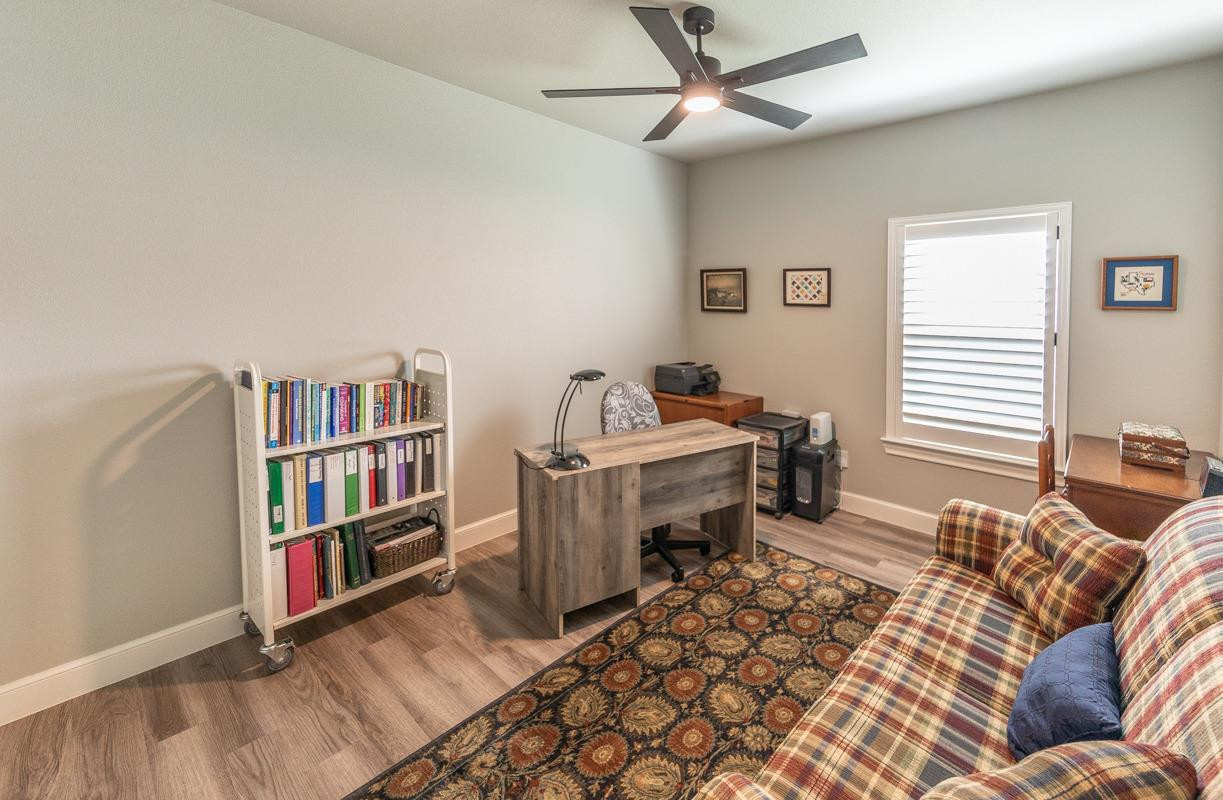 7002 103rd Street Lubbock, TX 79424 - Photo 16 of 28 a living room with a couch and a book shelf