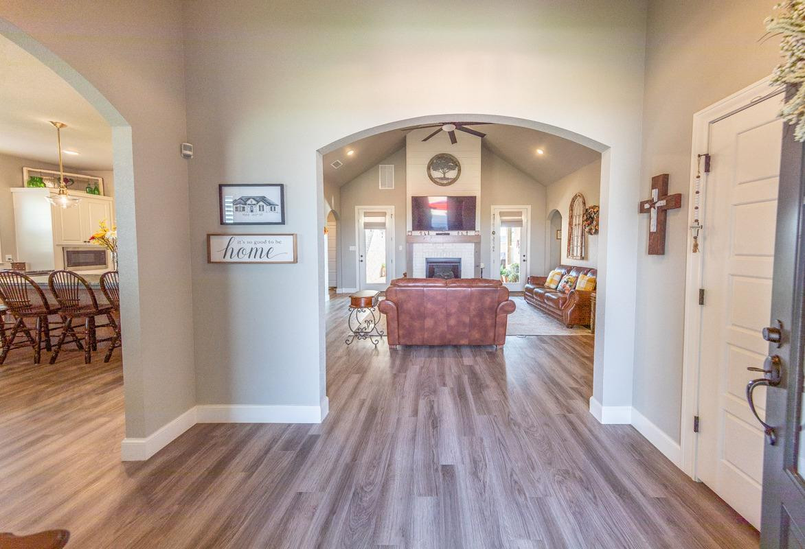 7002 103rd Street Lubbock, TX 79424 - Photo 2 of 28 a living room with furniture and a wooden floor