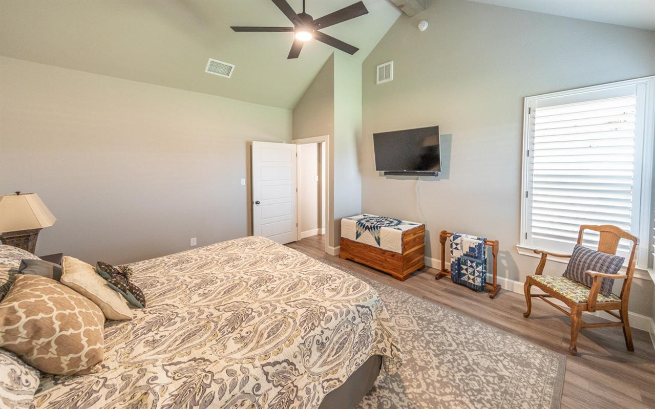 7002 103rd Street Lubbock, TX 79424 - Photo 21 of 28 a bedroom with a bed and a television