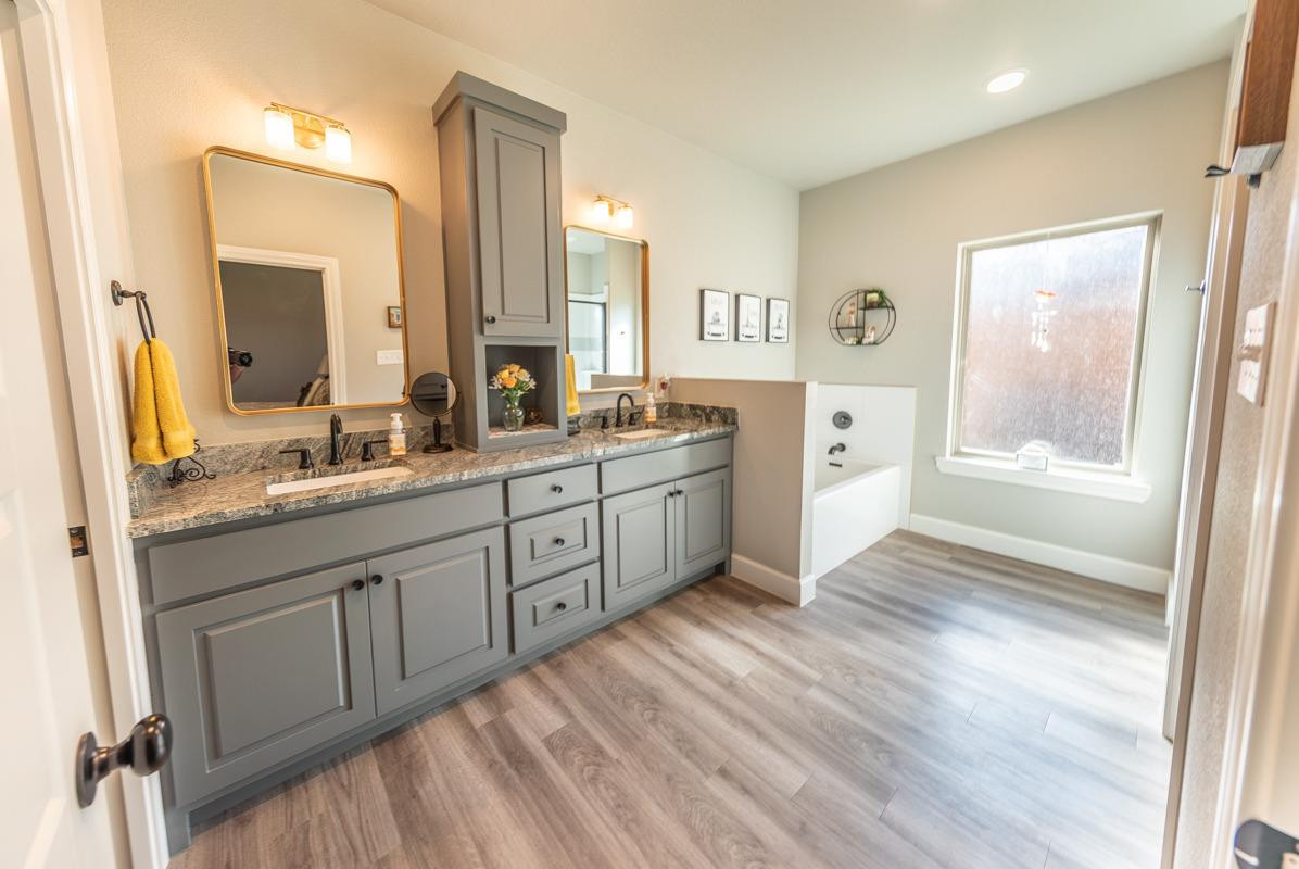 7002 103rd Street Lubbock, TX 79424 - Photo 22 of 28 a spacious bathroom with a granite countertop sink mirror and a
