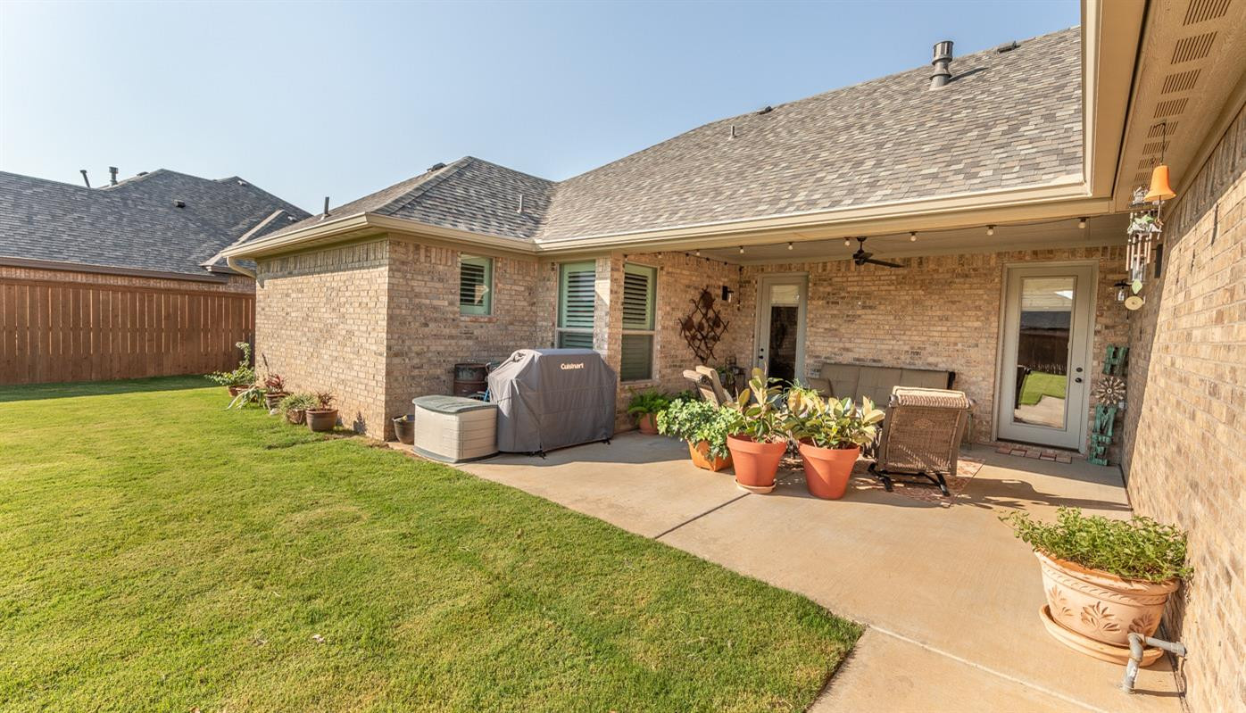 7002 103rd Street Lubbock, TX 79424 - Photo 25 of 28 a front view of a house with yard