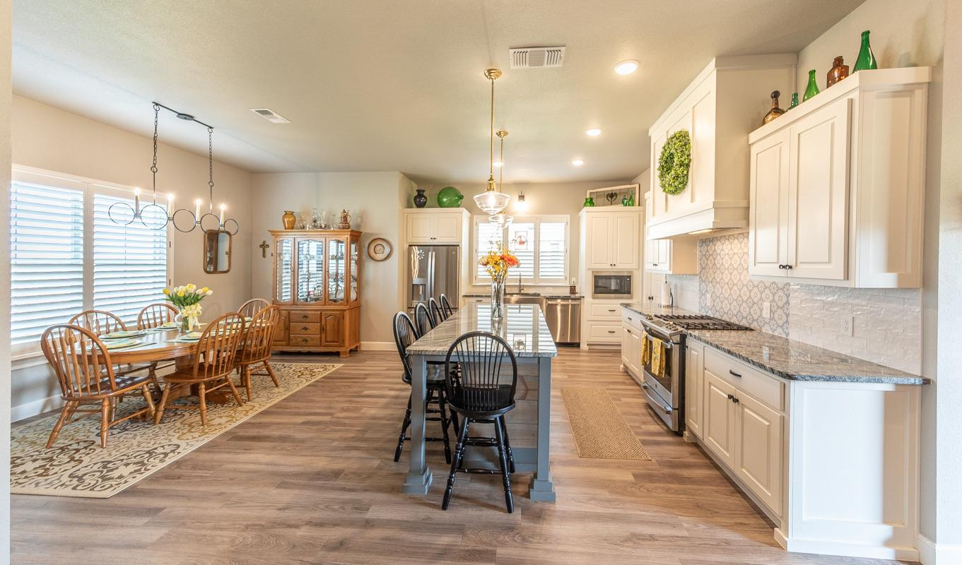 7002 103rd Street Lubbock, TX 79424 - Photo 3 of 28 a large kitchen with lots of counter space and windows