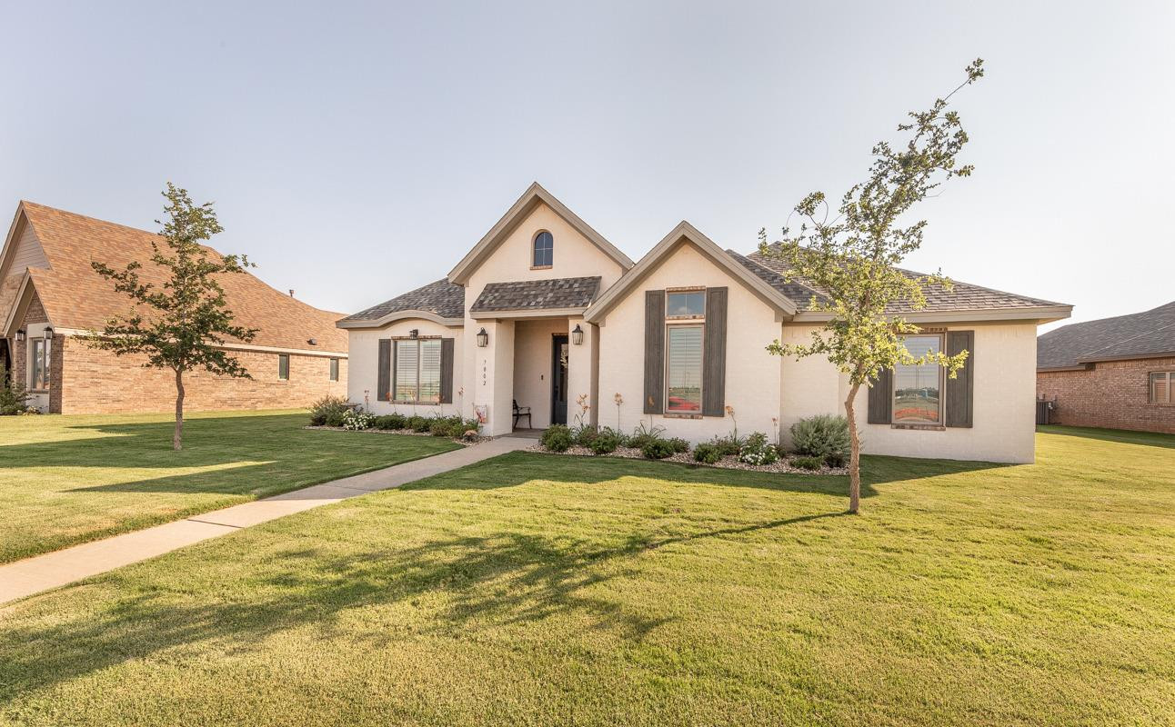 7002 103rd Street Lubbock, TX 79424 - Photo 5 of 28 a front view of a house with a yard