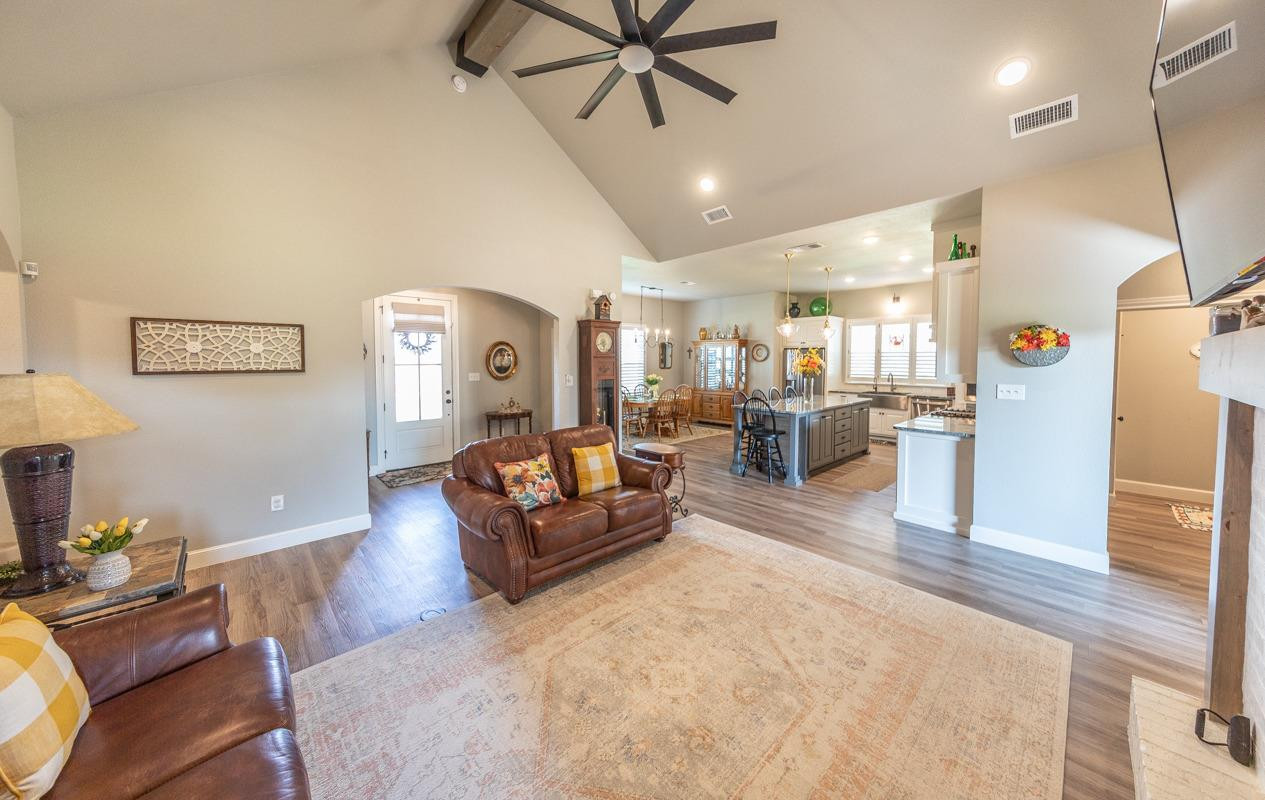 7002 103rd Street Lubbock, TX 79424 - Photo 7 of 28 a living room with furniture and a flat screen tv