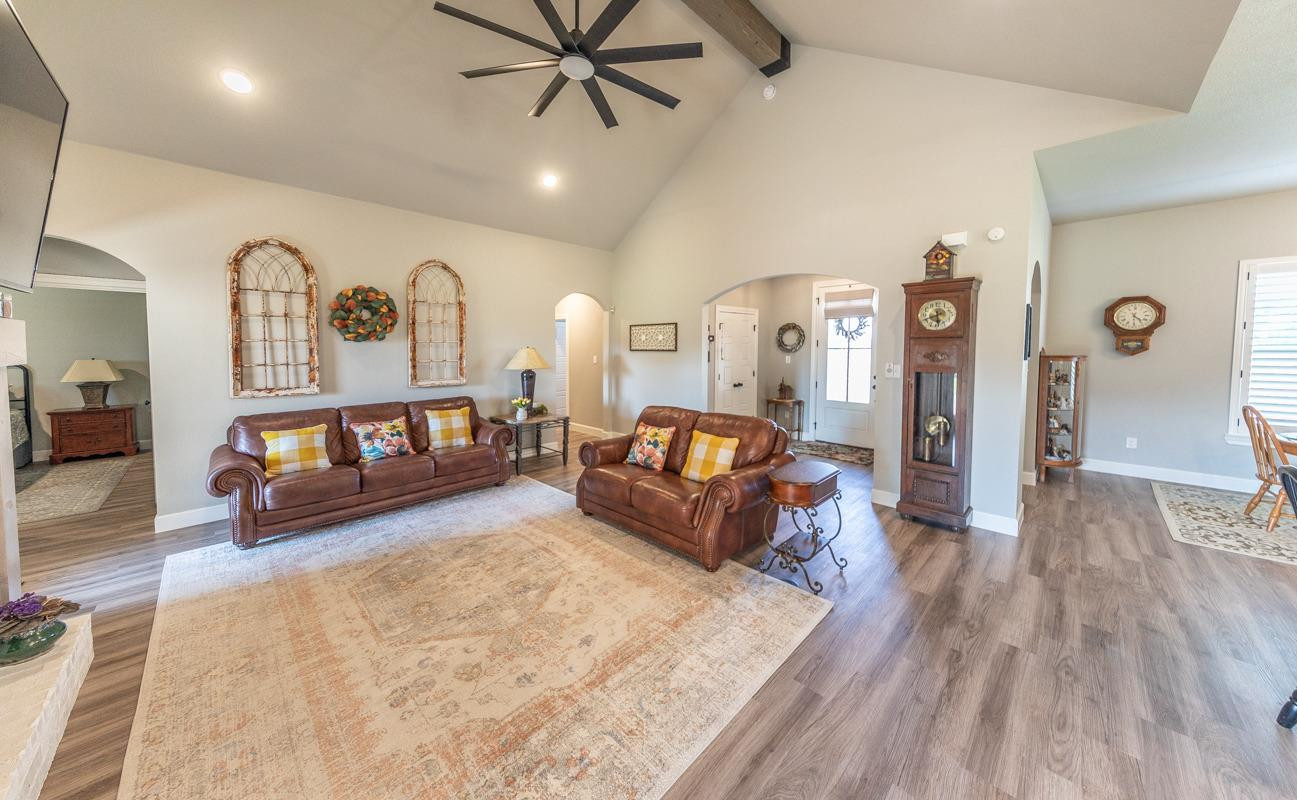 7002 103rd Street Lubbock, TX 79424 - Photo 8 of 28 a living room with furniture and a wooden floor