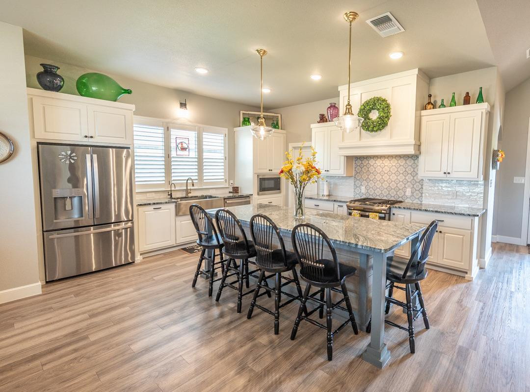7002 103rd Street Lubbock, TX 79424 - Photo 9 of 28 a view of a dining room with furniture window and wooden floor